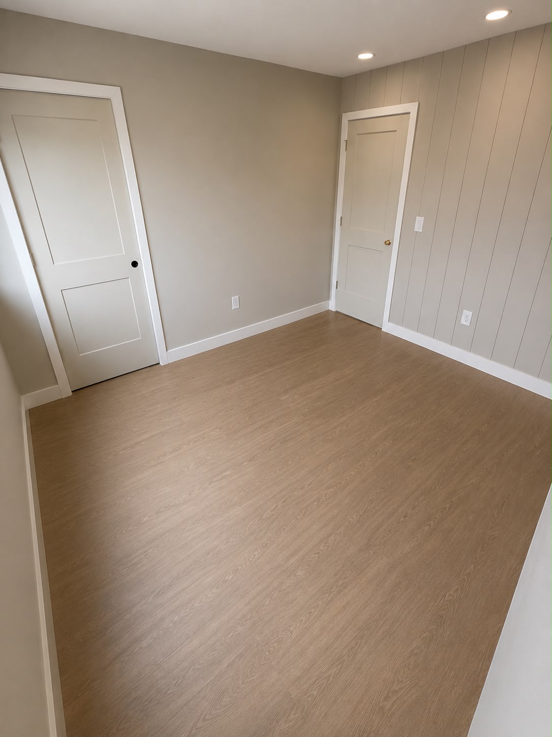 Finished bedroom with new baseboards and paneling