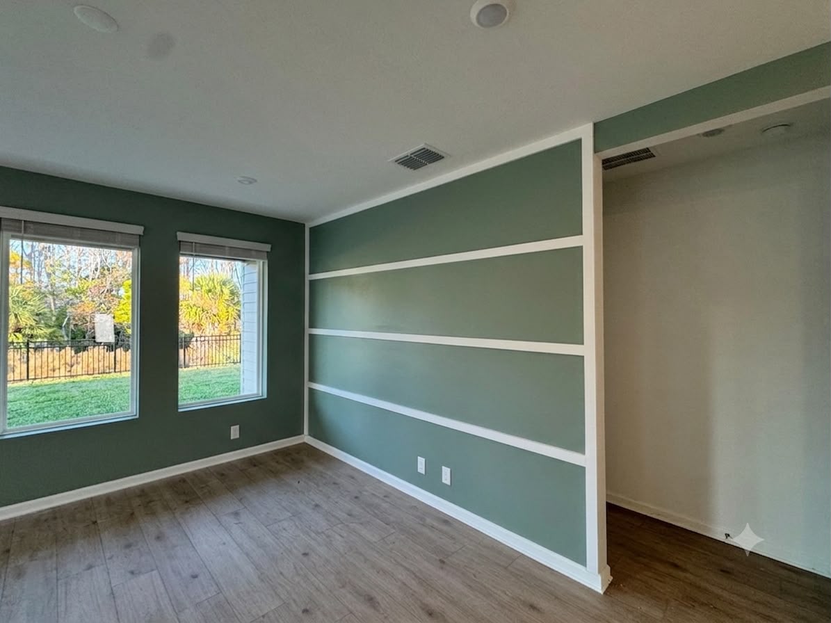 Green accent wall with white rails